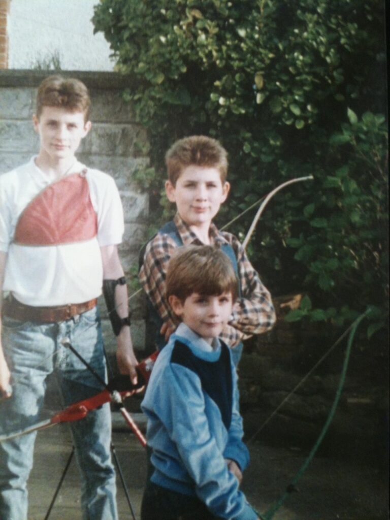 L-R: Lee, Stuart and front Darrel 
Practicing in the garden, circa 1987